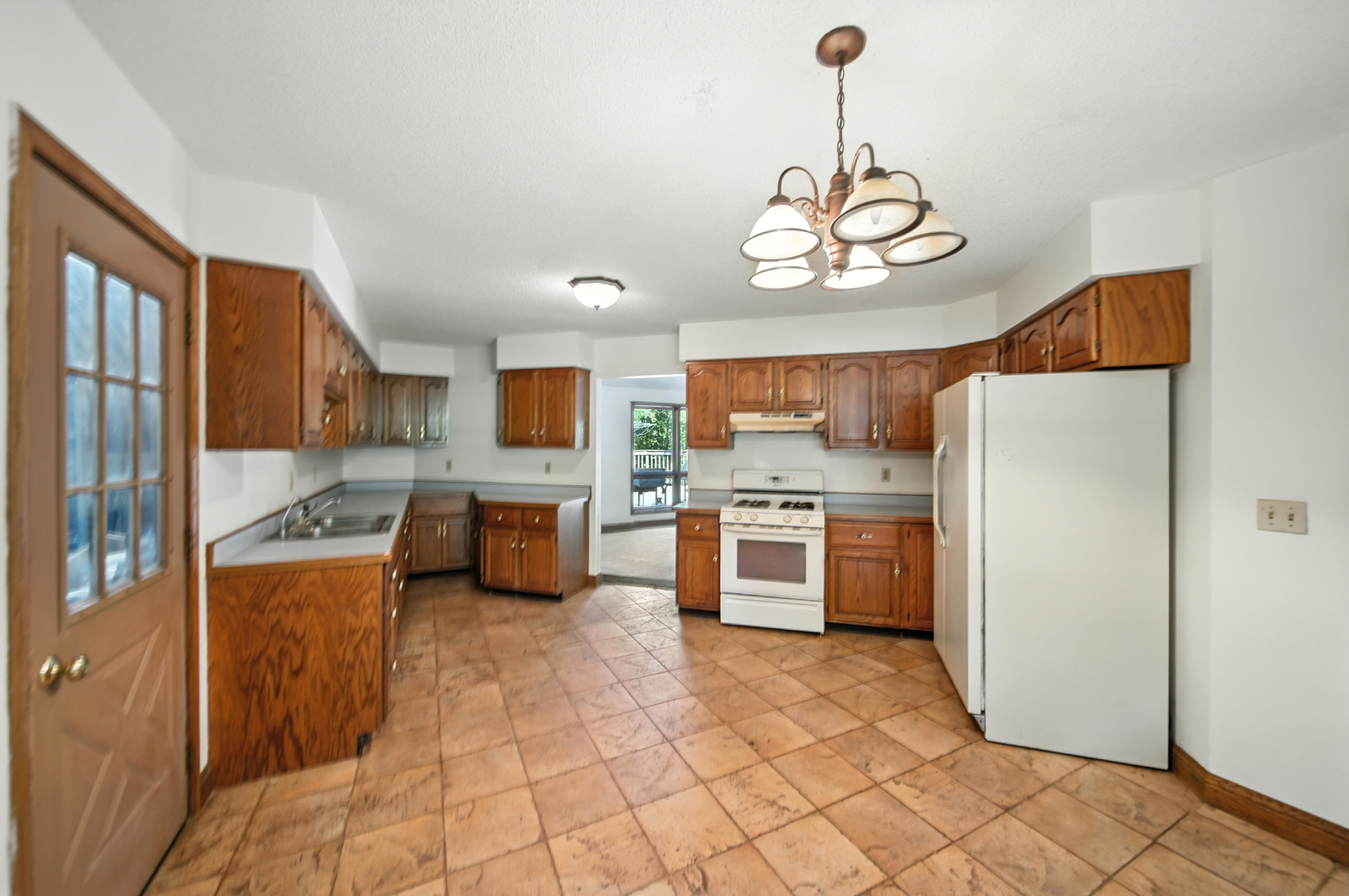 21631 Hoover Road Sterling, IL 61081 - Photo 17 of 30 a kitchen with stainless steel appliances granite countertop a stove a refrigerator a oven and white cabinets