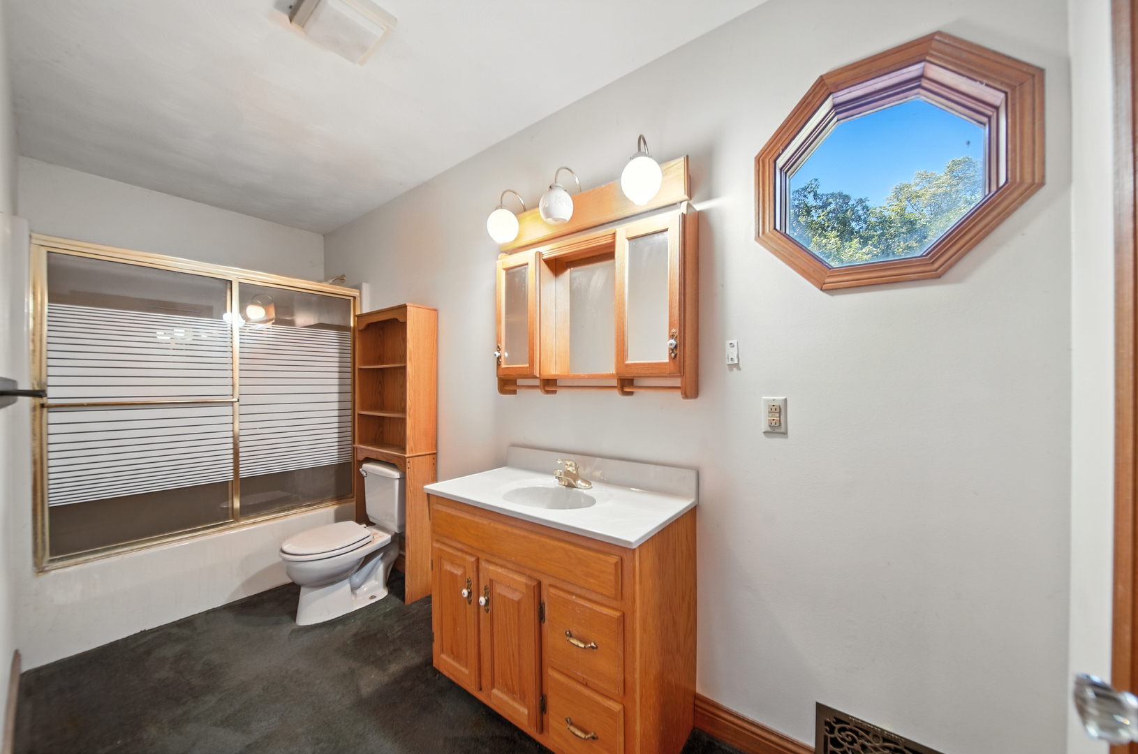 21631 Hoover Road Sterling, IL 61081 - Photo 22 of 30 a bathroom with a sink a toilet and a mirror