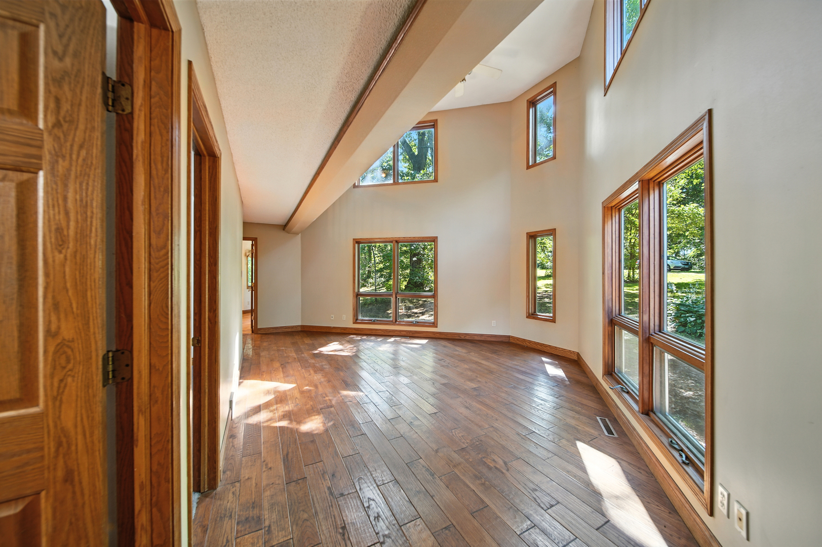 21631 Hoover Road Sterling, IL 61081 - Photo 7 of 30 a view of an empty room with wooden floor and a window