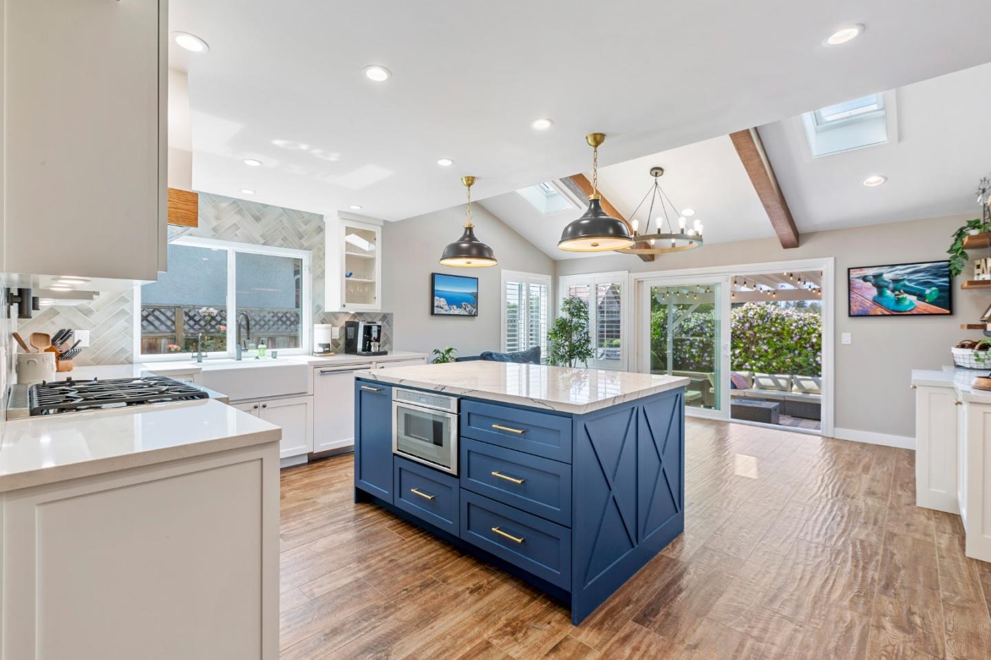 a kitchen with stainless steel appliances granite countertop a sink stove and wooden floors