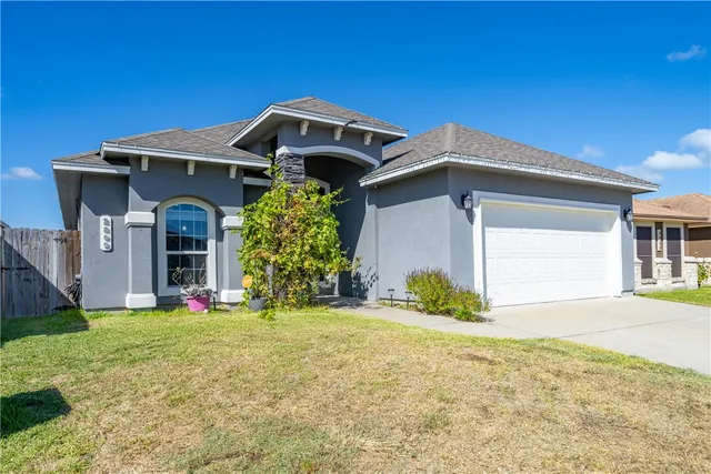 a front view of a house with a yard