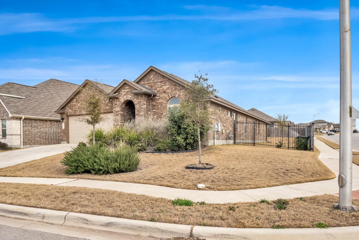 539 Merlin Lane Leander, TX 78641 - Photo 2 of 18 View of front of home featuring brick siding, concrete driveway, and an attached garage