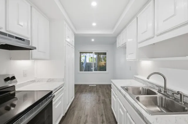 a bedroom with a bed and a potted plant