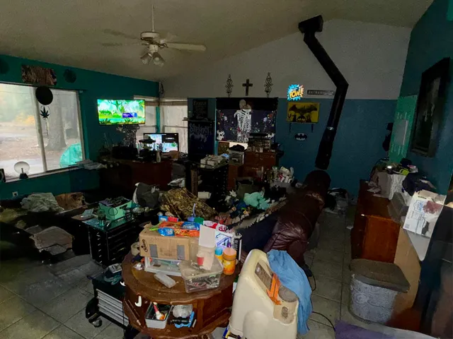 a room with lots of flowers and a dining table