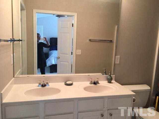 7010 Mead Lane Raleigh, NC 27613 - Photo 16 of 22 a bathroom with a sink and a mirror