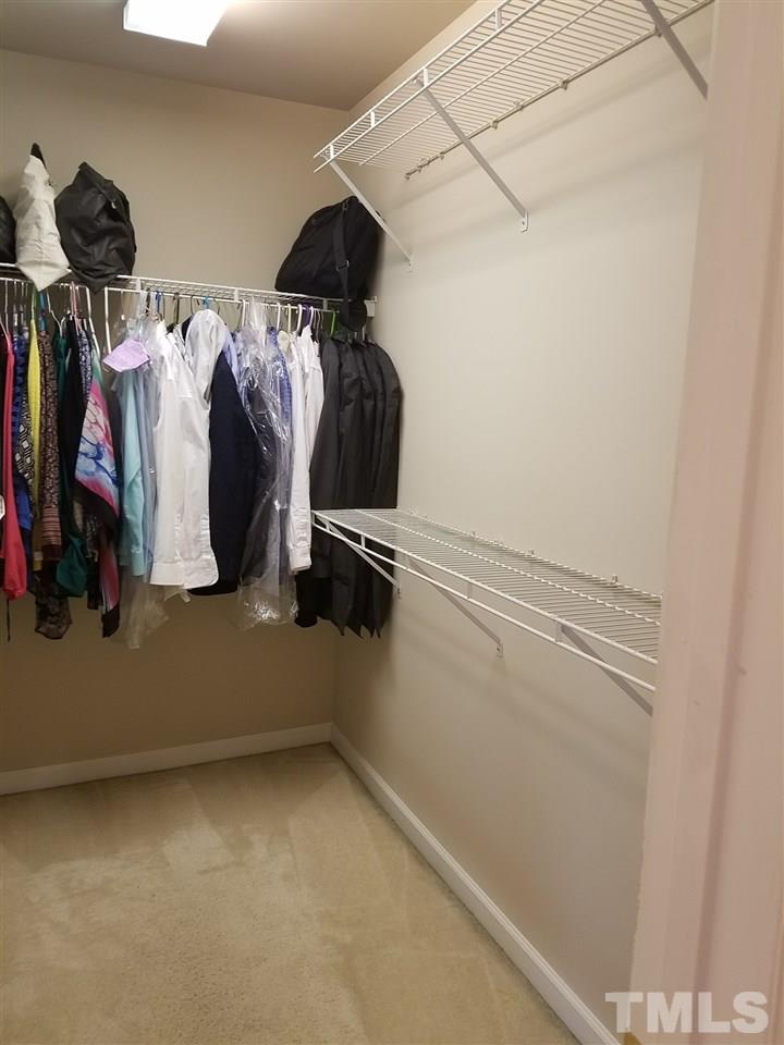 7010 Mead Lane Raleigh, NC 27613 - Photo 17 of 22 a view of walk in closet with clothes and shoes