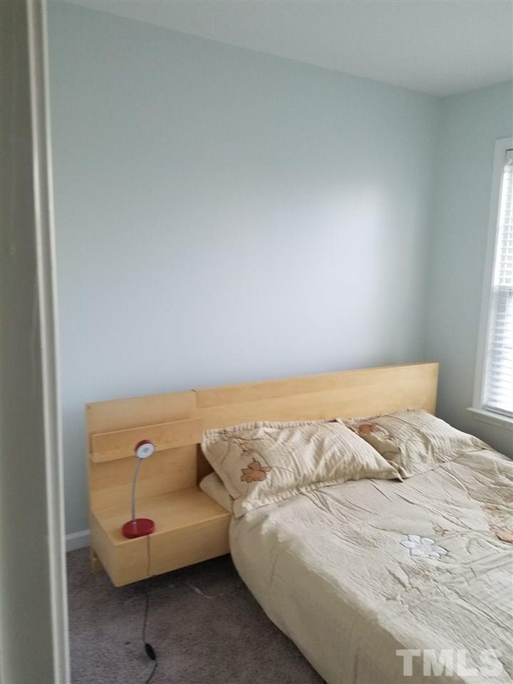 7010 Mead Lane Raleigh, NC 27613 - Photo 18 of 22 a bedroom with a bed and a couch