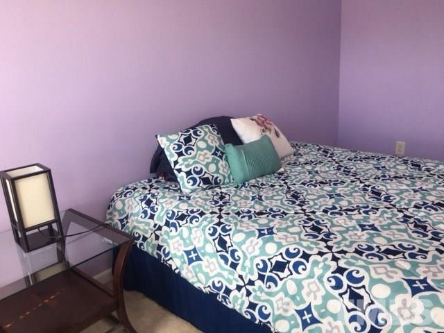 7010 Mead Lane Raleigh, NC 27613 - Photo 19 of 22 a bed sitting in a bedroom next to a lamp