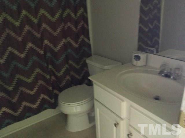 7010 Mead Lane Raleigh, NC 27613 - Photo 20 of 22 a white toilet sitting next to a bath tub
