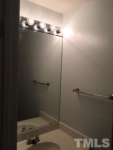 7010 Mead Lane Raleigh, NC 27613 - Photo 5 of 22 a bathroom with a granite countertop sink and vanity
