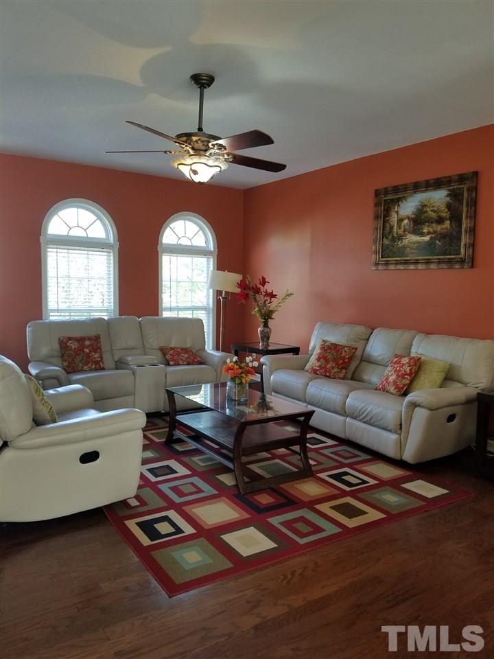 7010 Mead Lane Raleigh, NC 27613 - Photo 8 of 22 a living room with furniture a chandelier and a window