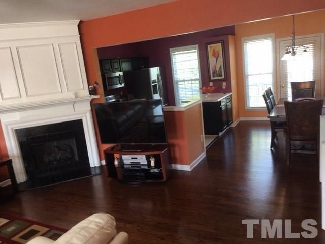 7010 Mead Lane Raleigh, NC 27613 - Photo 9 of 22 a living room with furniture wooden floor and a fireplace