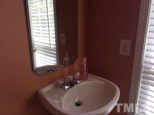 7010 Mead Lane Raleigh, NC 27613 - Photo 10 of 22 a bathroom with a sink and a window