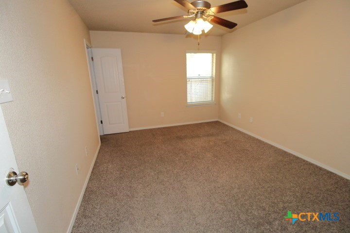 911 Brookview Drive, Unit A Copperas Cove, TX 76522 - Photo 12 of 13 an empty room with windows and fan