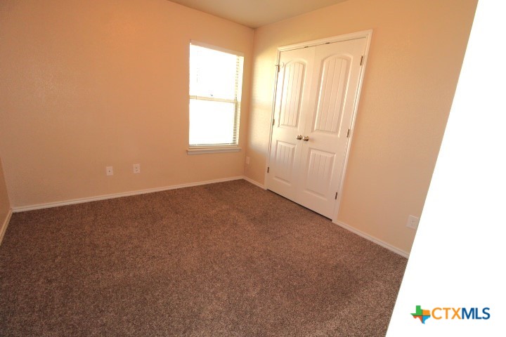 911 Brookview Drive, Unit A Copperas Cove, TX 76522 - Photo 8 of 13 an empty room with windows