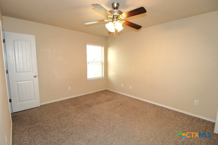 911 Brookview Drive, Unit A Copperas Cove, TX 76522 - Photo 9 of 13 an empty room with windows and fan
