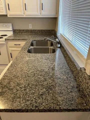a kitchen with a stove and a window