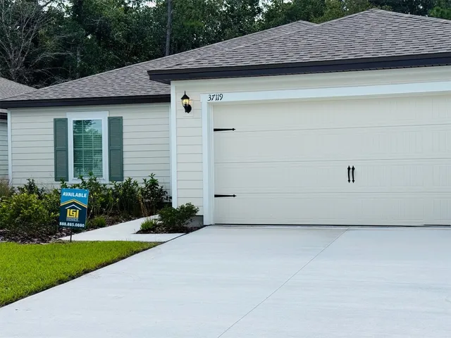 a view of a house with a wooden fence