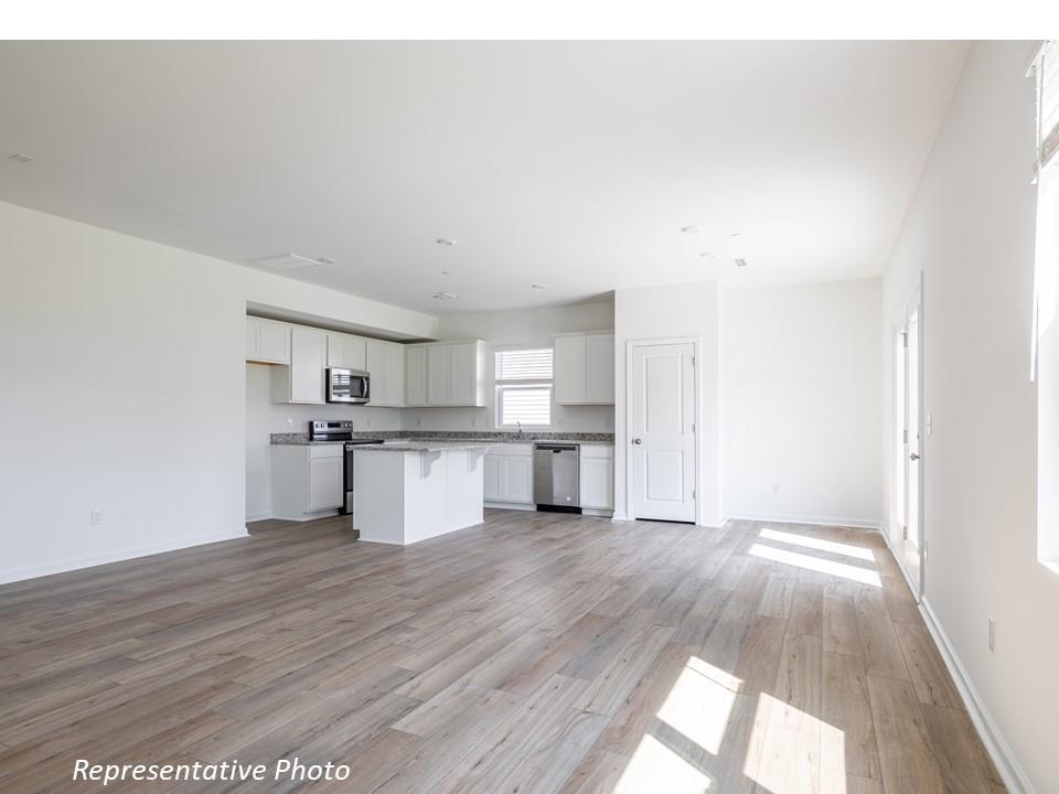 1248 Maple Shade Road Southwest, Unit 74 Concord, NC 28027 - Photo 3 of 11 a view of a kitchen with wooden floor