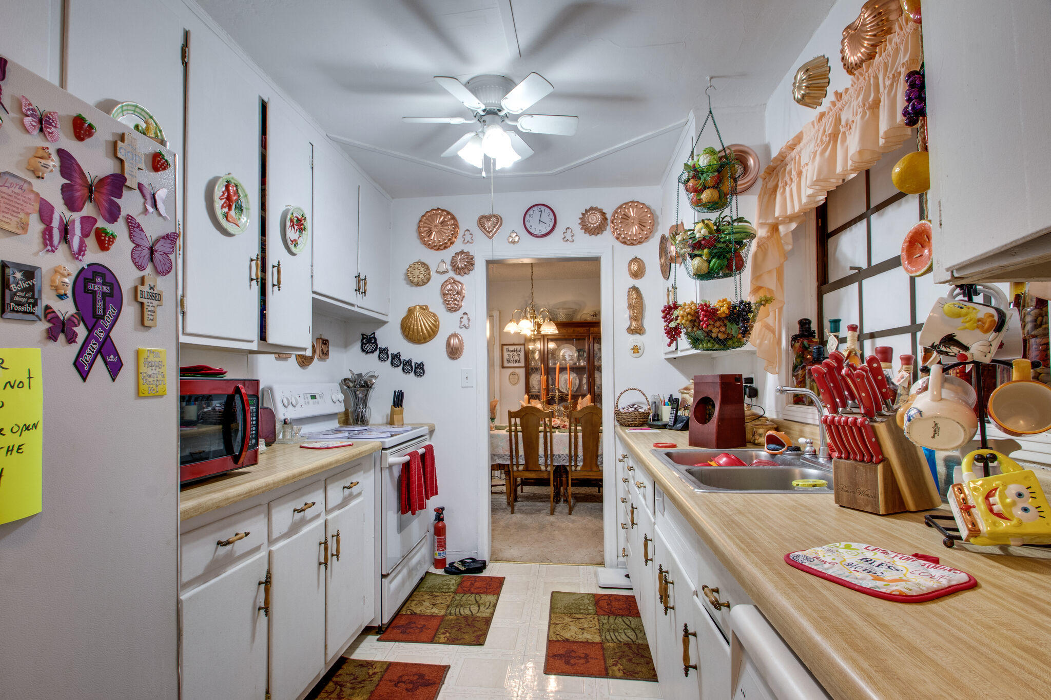 333 Edge Avenue Valparaiso, FL 32580 - Photo 14 of 37 a kitchen with stainless steel appliances kitchen island granite countertop lots of clutter and cabinets