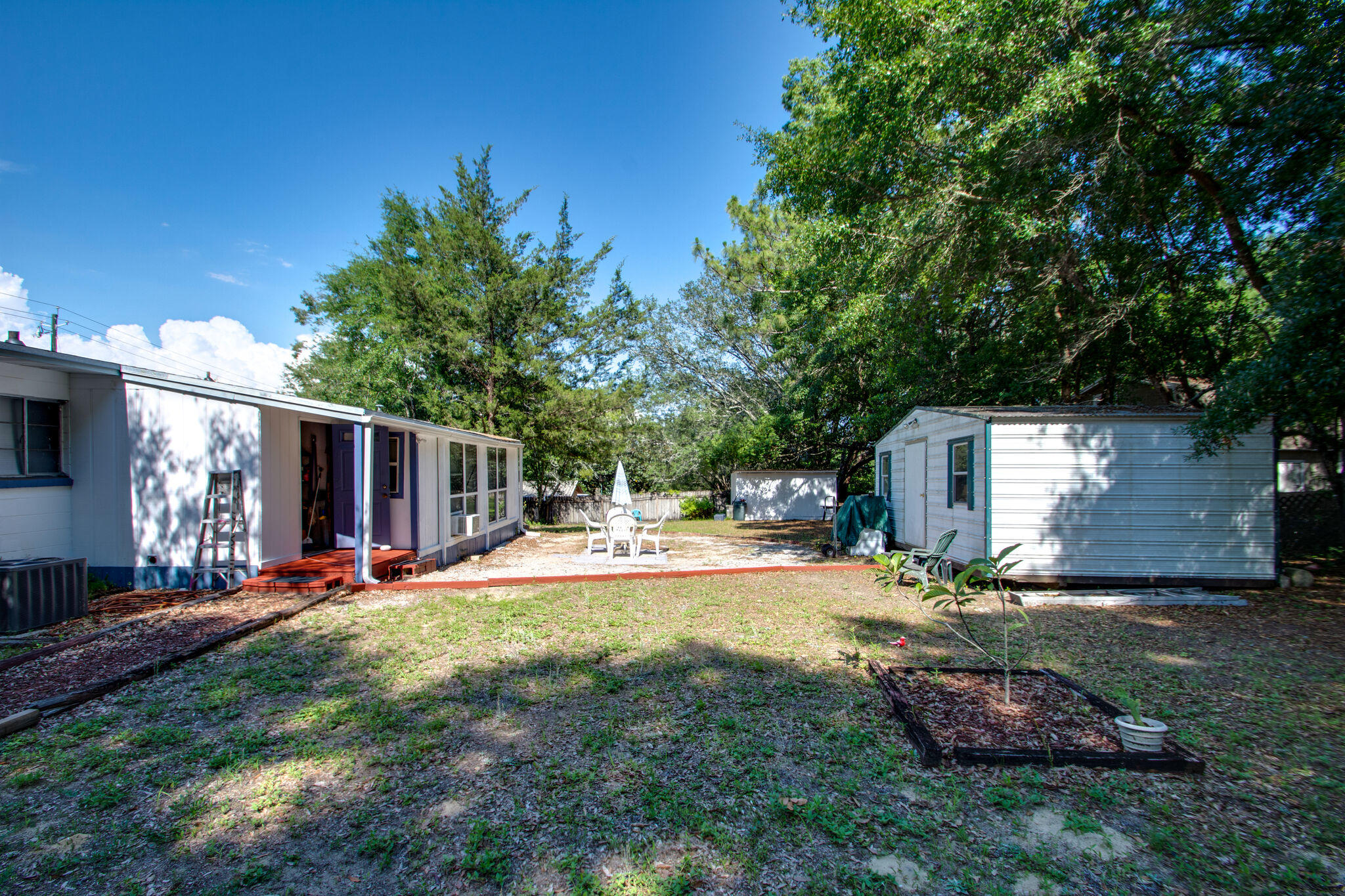 333 Edge Avenue Valparaiso, FL 32580 - Photo 32 of 37 a view of a backyard with table and chairs and a large tree