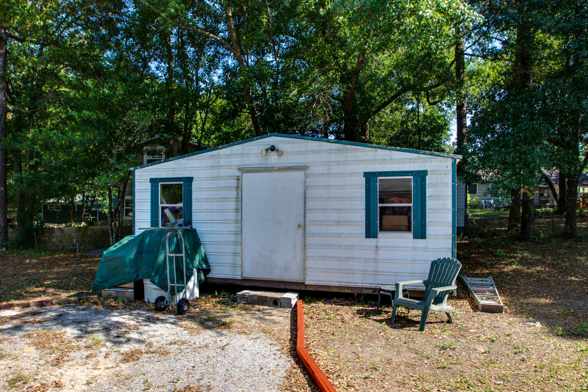 333 Edge Avenue Valparaiso, FL 32580 - Photo 33 of 37 a view of backyard with a chair under a large tree