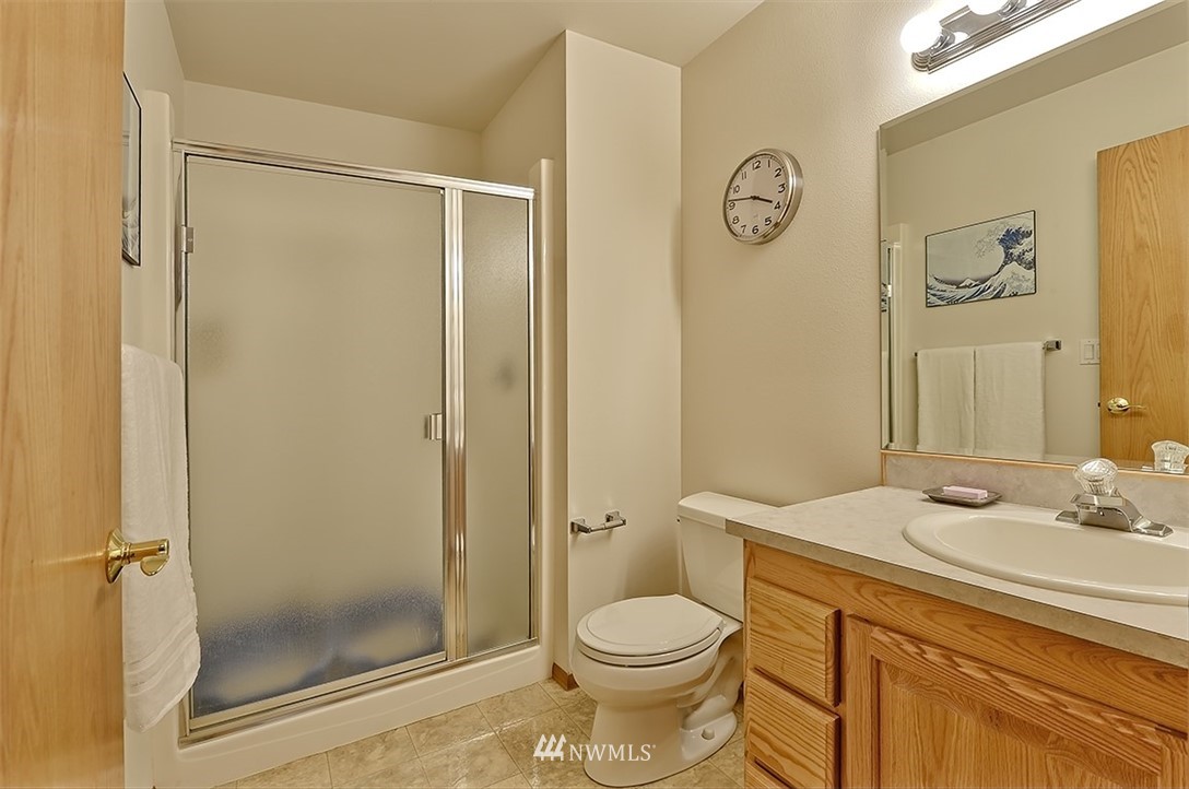 4192 West Road Blaine, WA 98230 - Photo 18 of 27 a bathroom with a granite countertop sink toilet and shower