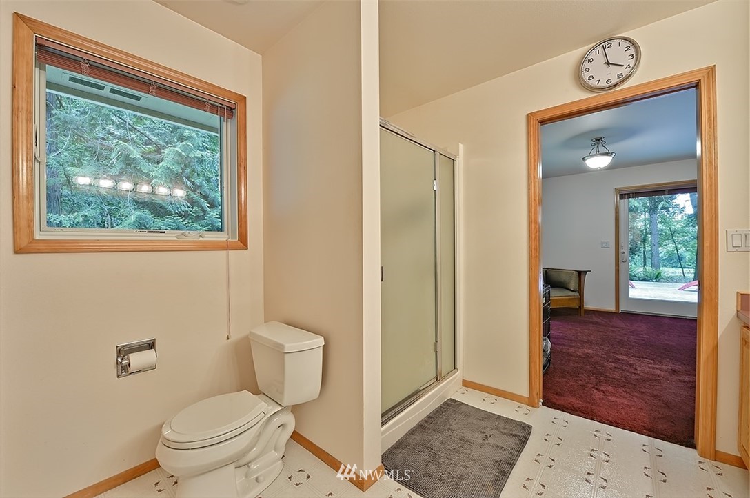 4192 West Road Blaine, WA 98230 - Photo 24 of 27 a bathroom with a toilet a sink and a window