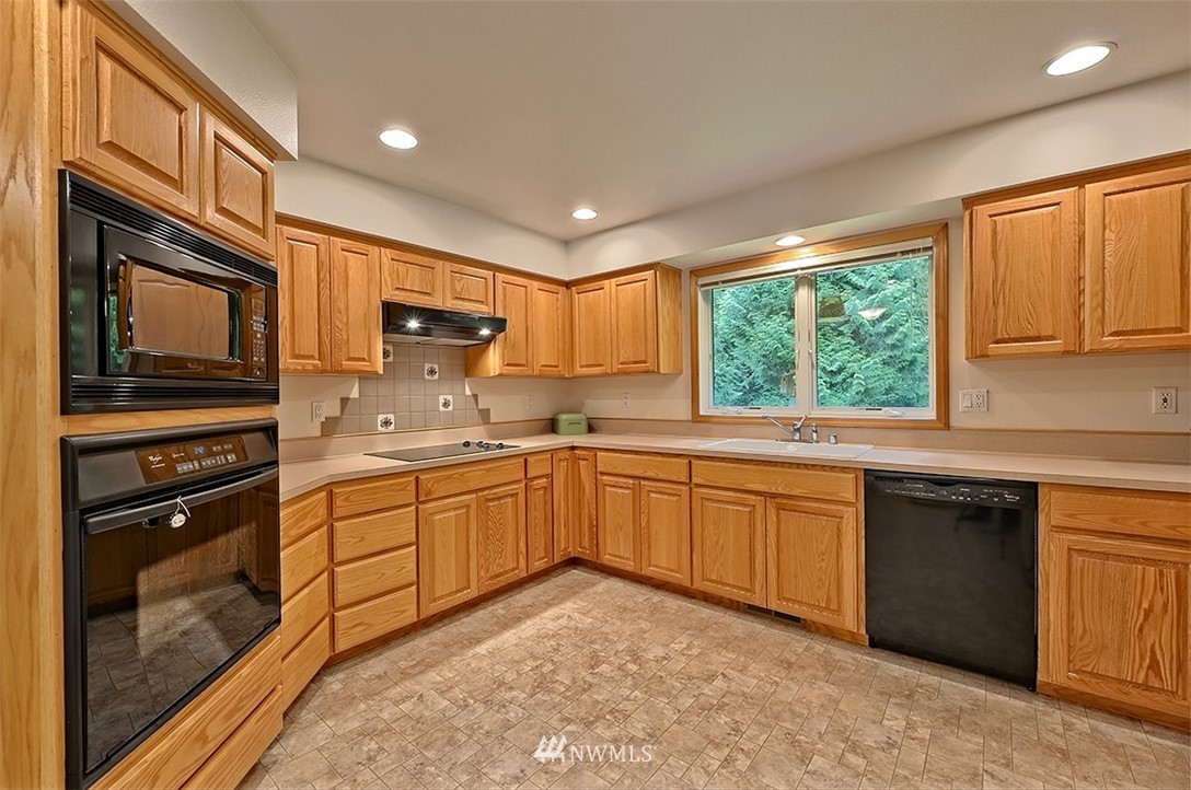 4192 West Road Blaine, WA 98230 - Photo 8 of 27 a kitchen with granite countertop appliances cabinets and a sink
