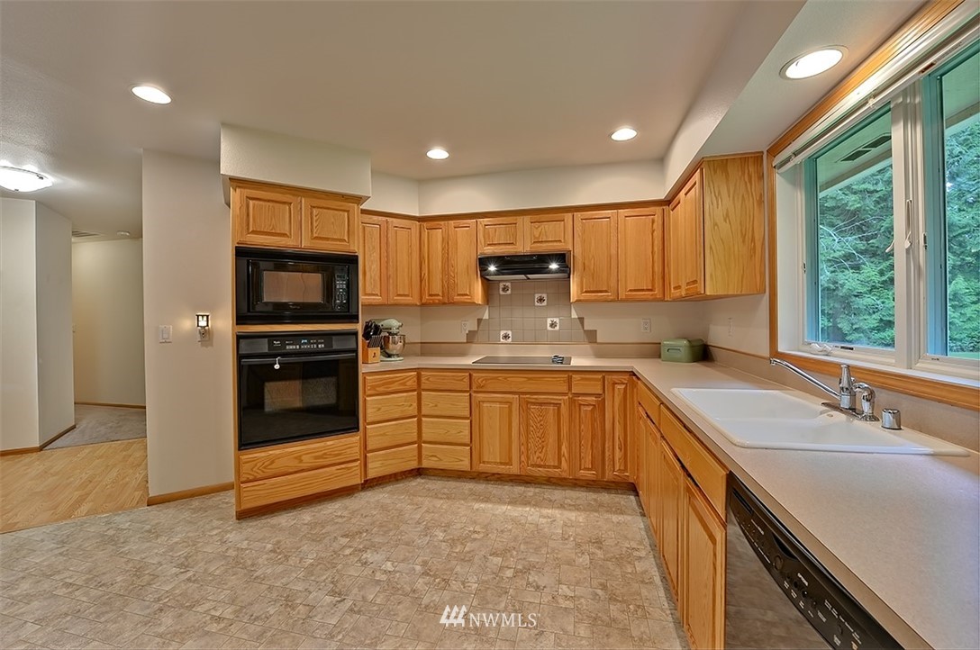 4192 West Road Blaine, WA 98230 - Photo 9 of 27 a kitchen with a sink a stove a microwave and cabinets