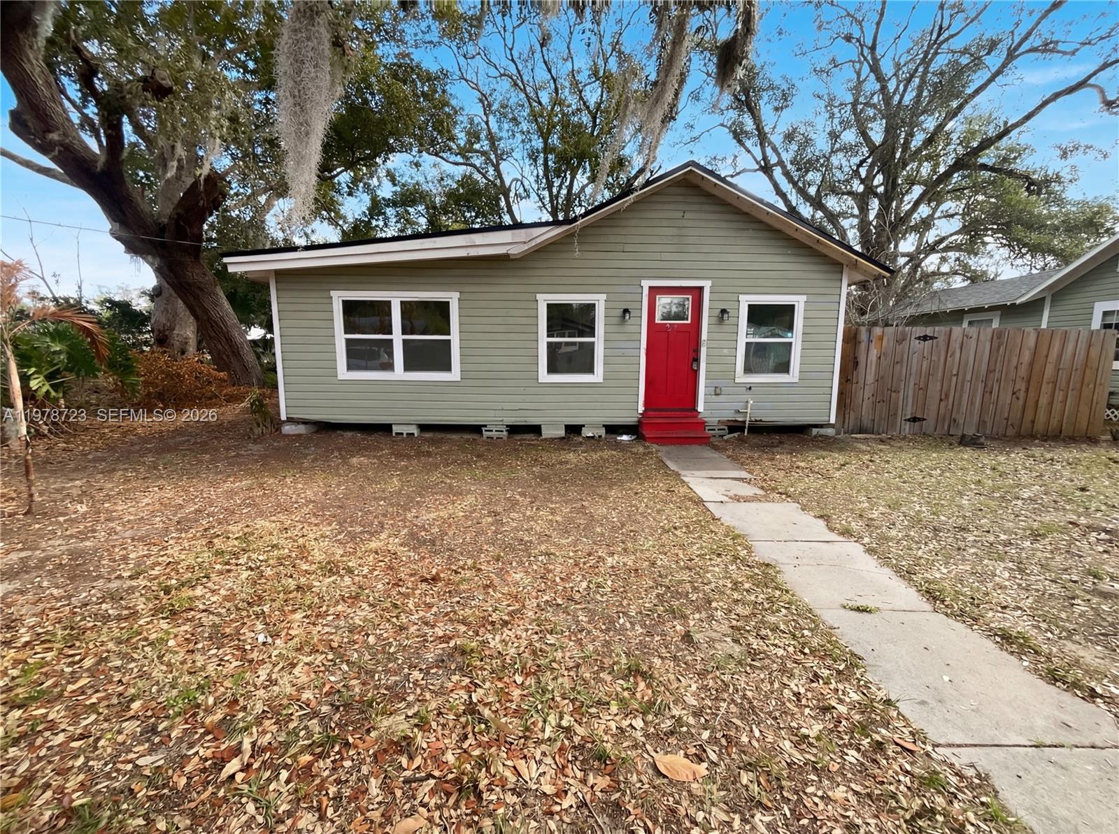 244 South Rhodes Street Mount Dora, FL 32757 - Photo 1 of 19 a front view of a house with a yard