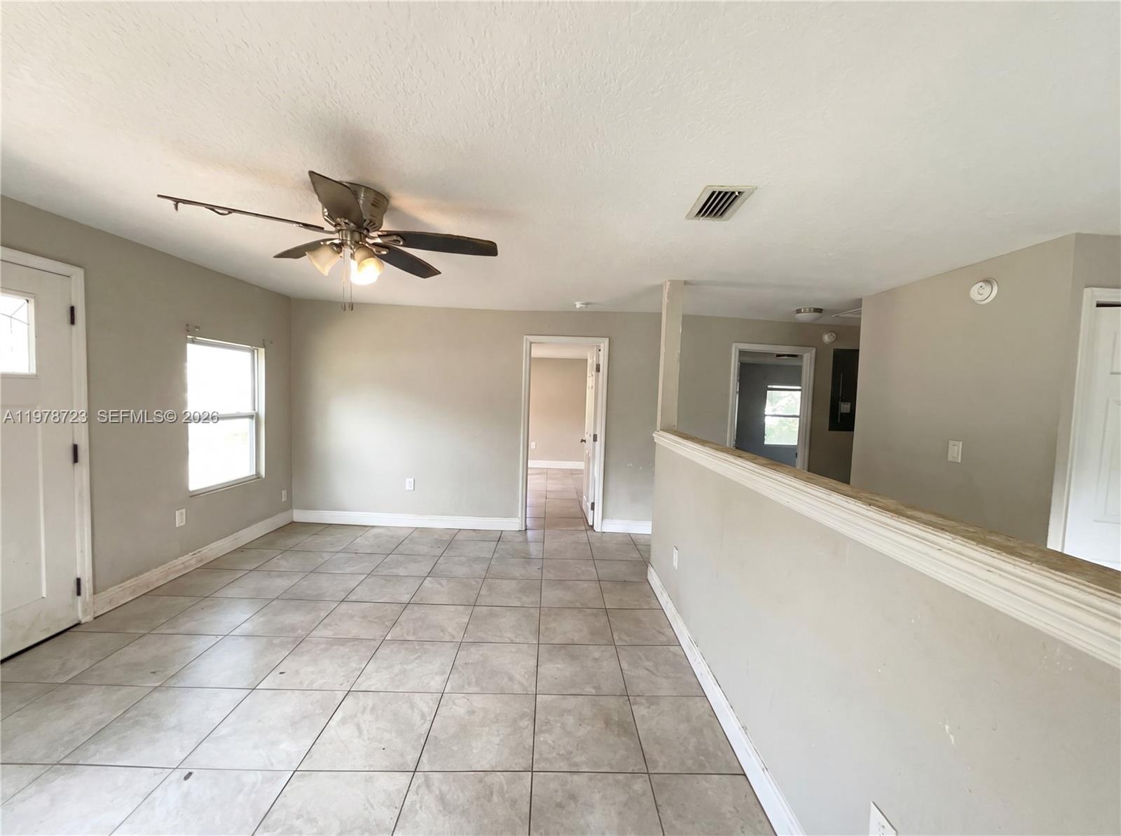 244 South Rhodes Street Mount Dora, FL 32757 - Photo 11 of 19 a view of a hallway with windows and chandelier fan