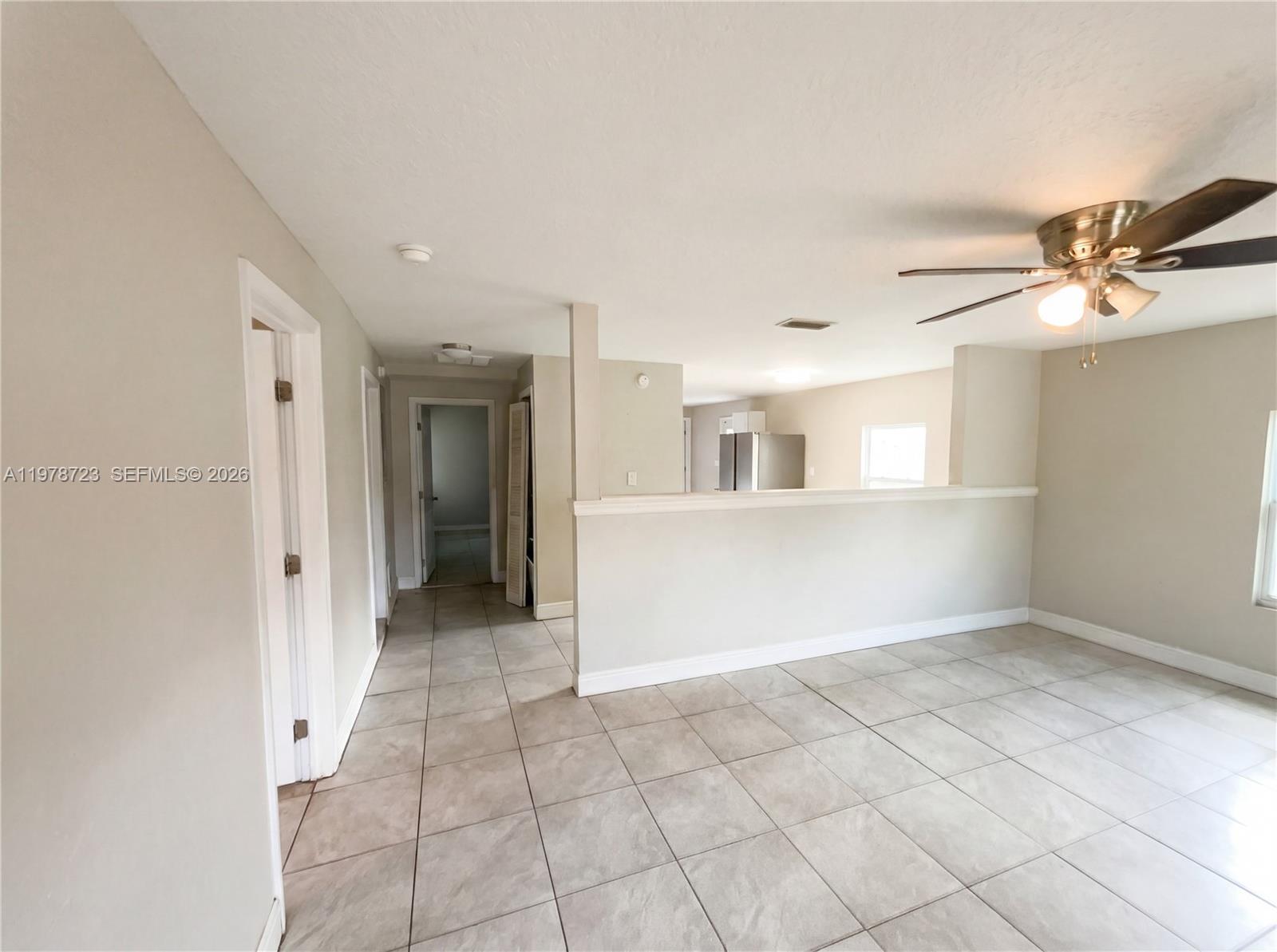 244 South Rhodes Street Mount Dora, FL 32757 - Photo 12 of 19 wooden floor in an empty room with a window