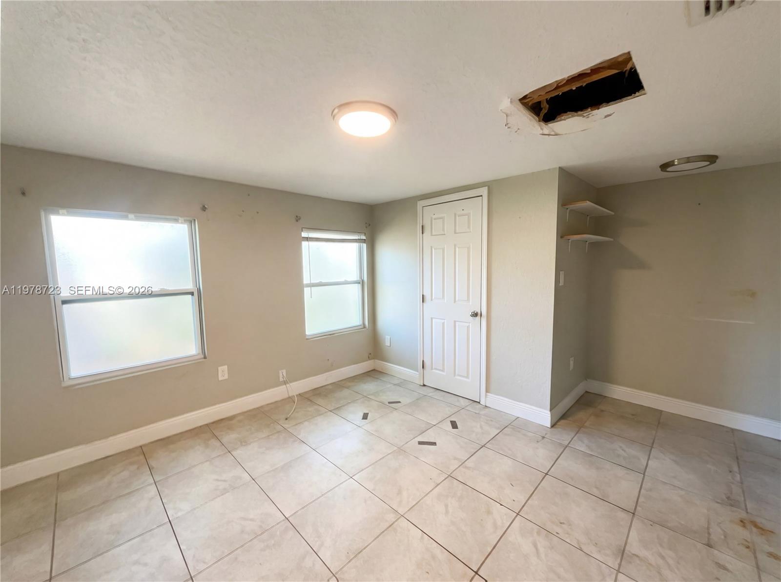 244 South Rhodes Street Mount Dora, FL 32757 - Photo 14 of 19 wooden floor in an empty room with a window