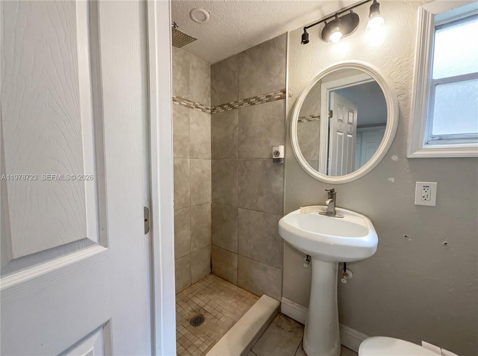 244 South Rhodes Street Mount Dora, FL 32757 - Photo 16 of 19 a bathroom with a sink toilet and a mirror