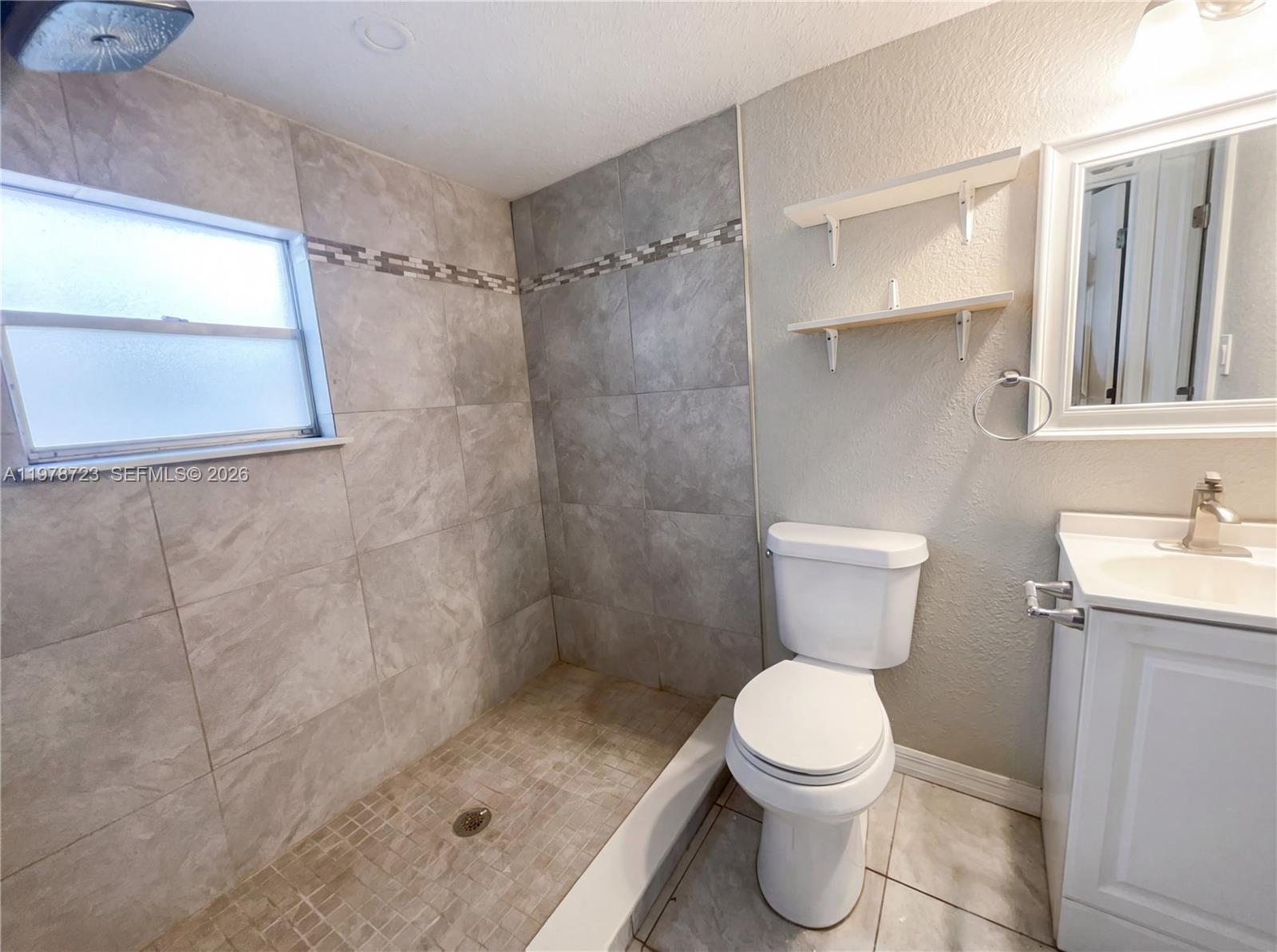 244 South Rhodes Street Mount Dora, FL 32757 - Photo 18 of 19 a bathroom with a toilet sink and shower