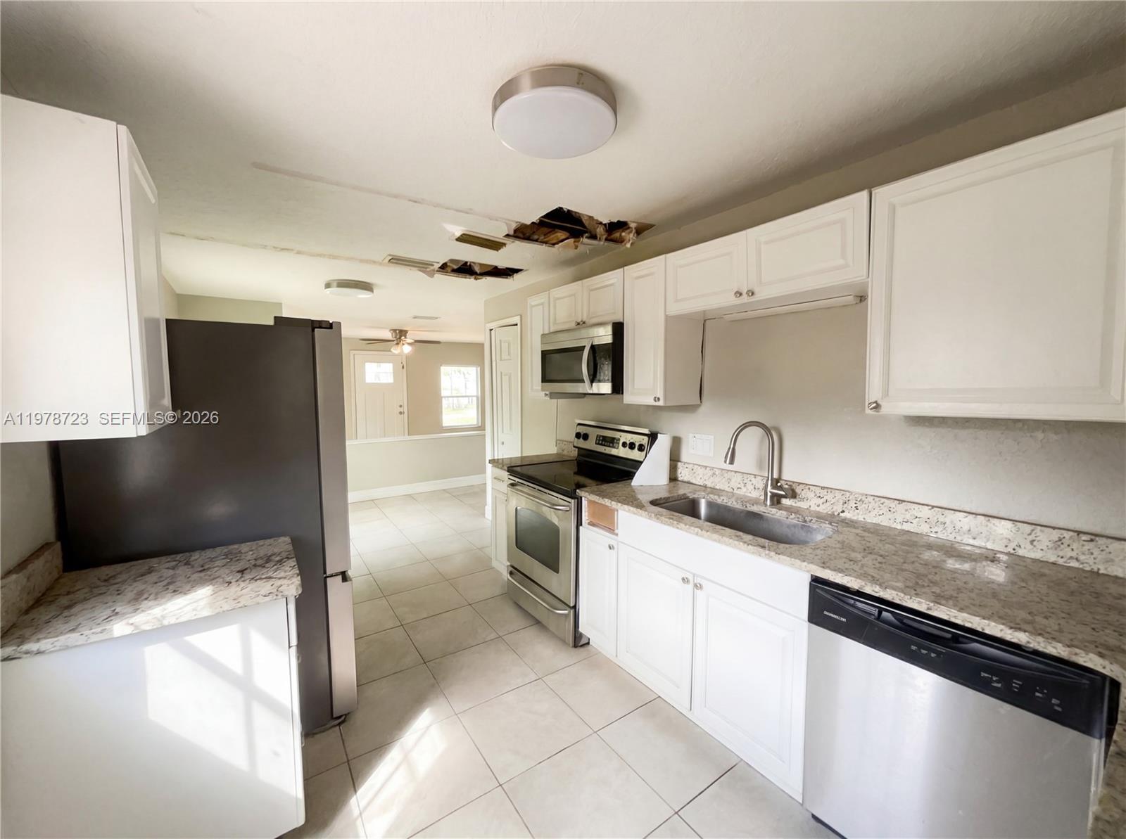 244 South Rhodes Street Mount Dora, FL 32757 - Photo 2 of 19 a kitchen with stainless steel appliances granite countertop a sink and a stove
