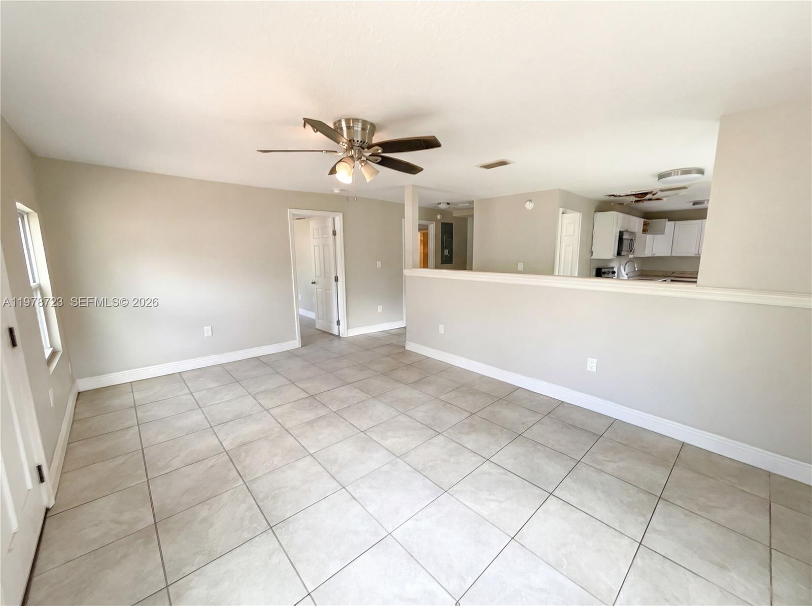 244 South Rhodes Street Mount Dora, FL 32757 - Photo 3 of 19 a view of a livingroom with a ceiling fan and window
