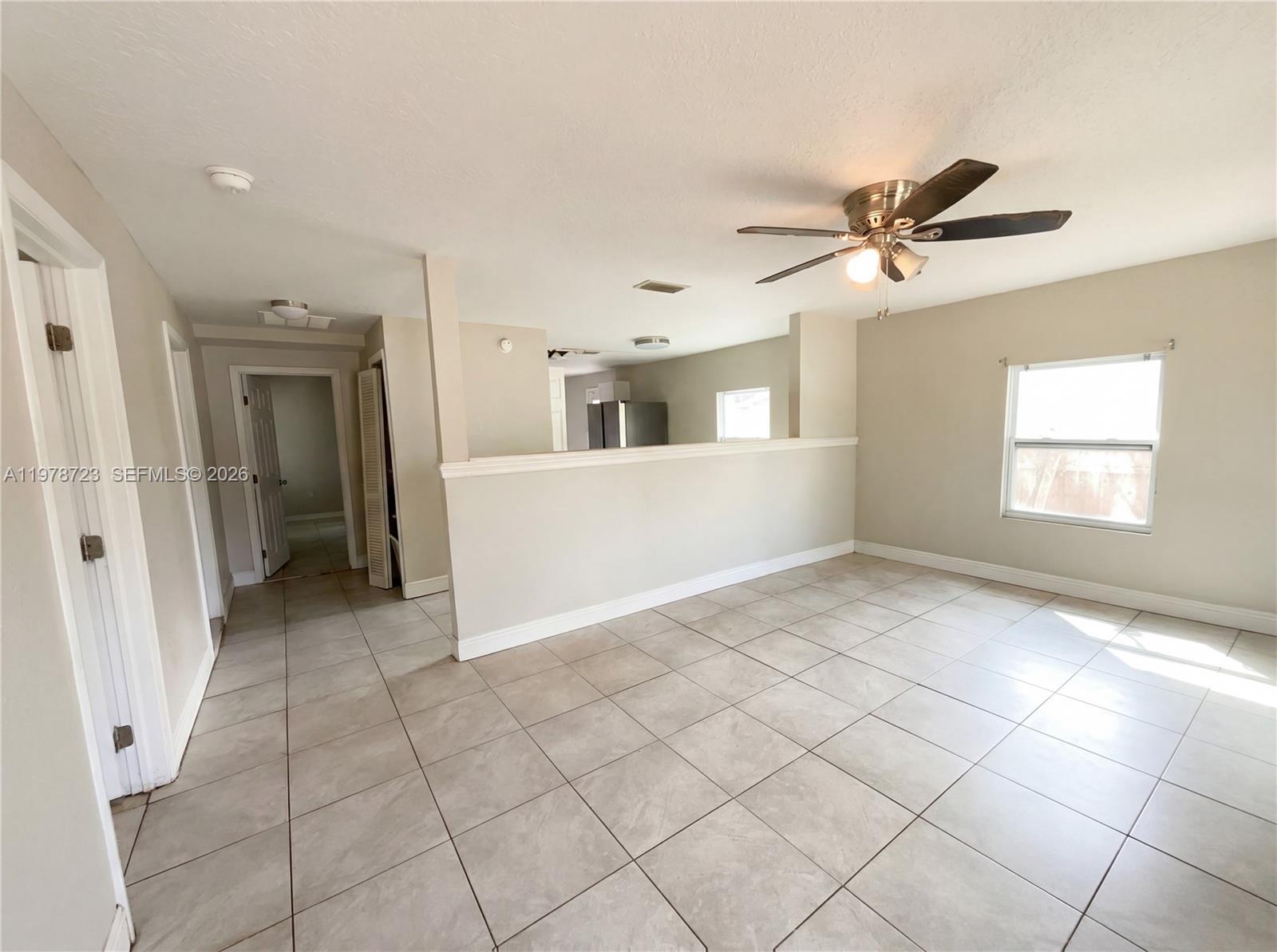 244 South Rhodes Street Mount Dora, FL 32757 - Photo 9 of 19 a view of a big room with windows and chandelier fan