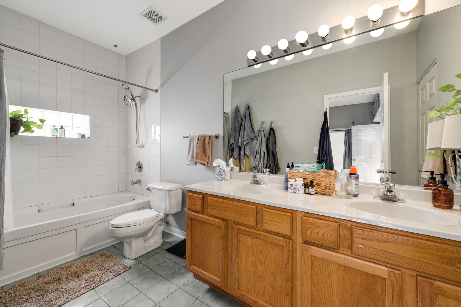 1359 West Fillmore Street, Unit A Chicago, IL 60607 - Photo 15 of 19 a bathroom with a double vanity sink mirror and toilet