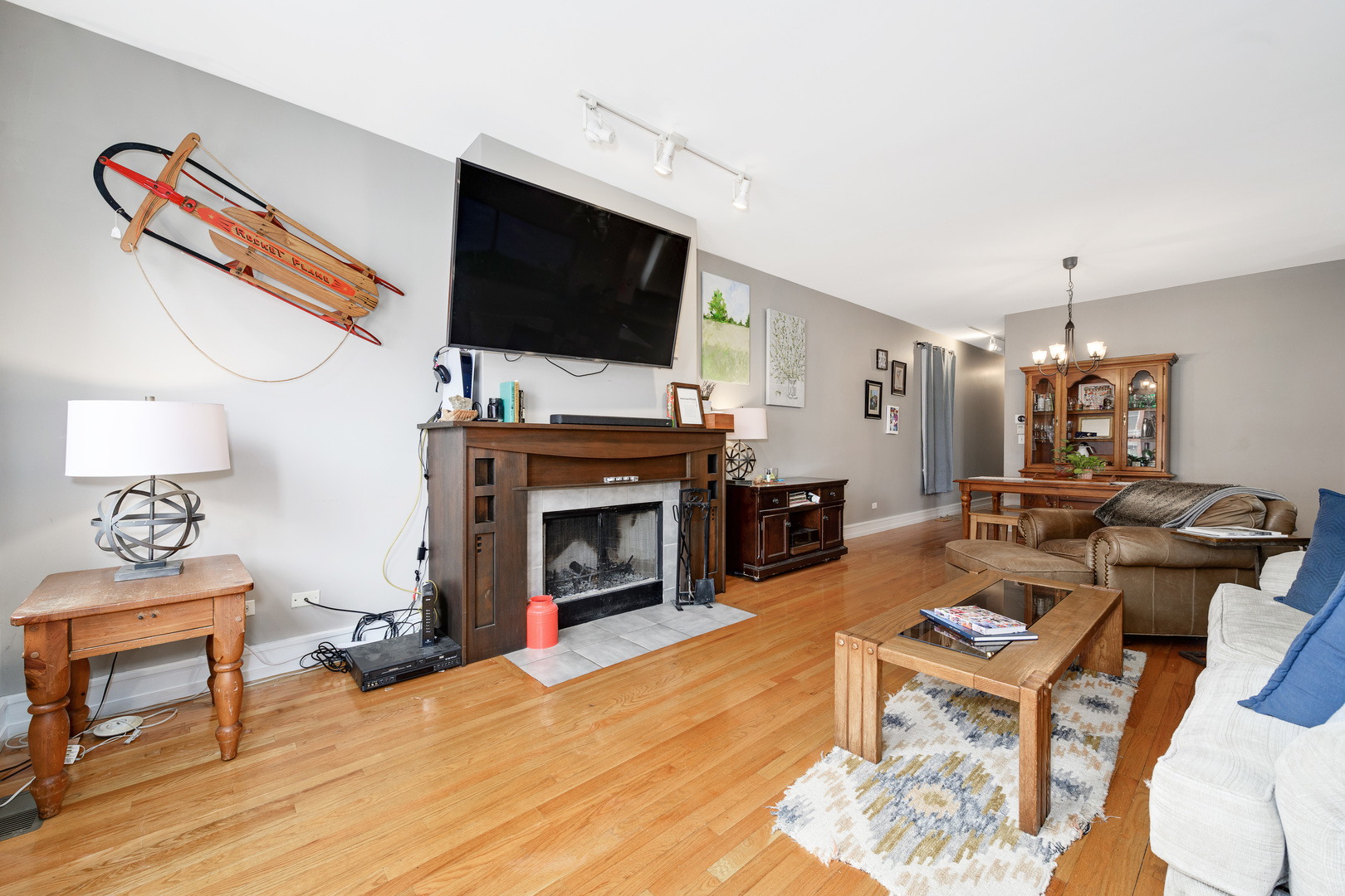 1359 West Fillmore Street, Unit A Chicago, IL 60607 - Photo 2 of 19 a living room with furniture a flat screen tv and a fireplace