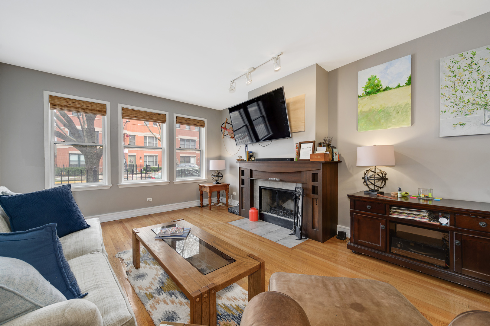 1359 West Fillmore Street, Unit A Chicago, IL 60607 - Photo 5 of 19 a living room with furniture a flat screen tv and a fireplace