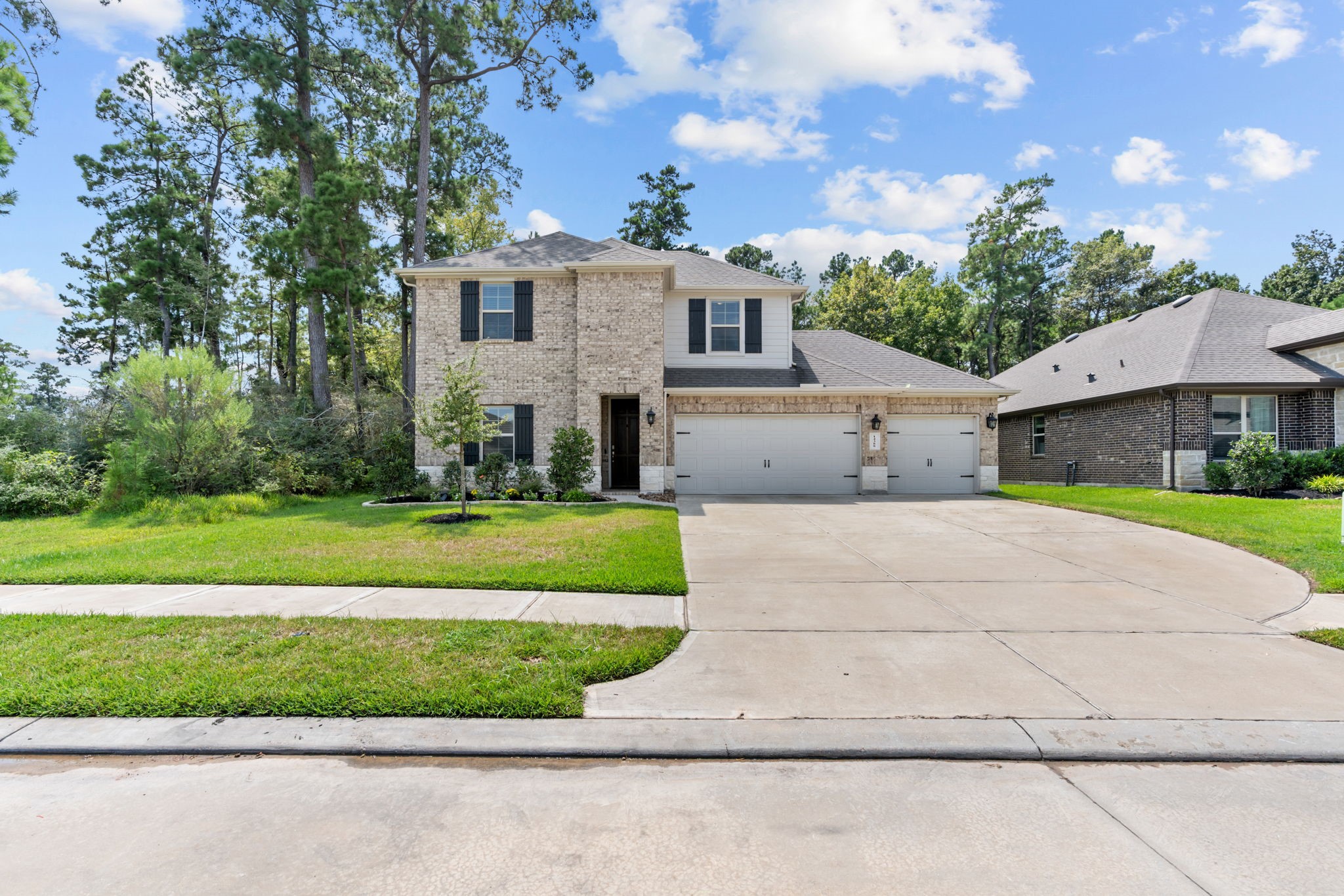 14388 Zion Gate Crossing Conroe, TX 77384 - Photo 2 of 33 a front view of a house with a yard
