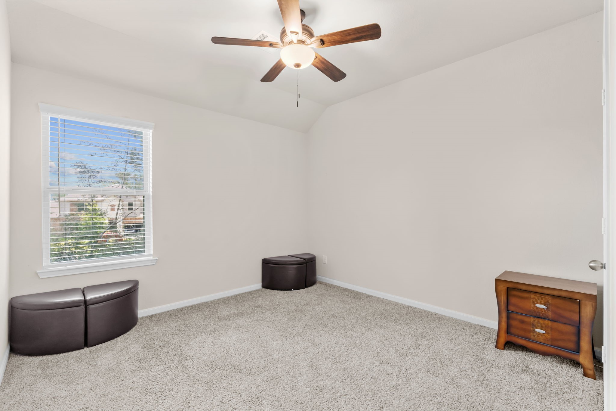 14388 Zion Gate Crossing Conroe, TX 77384 - Photo 25 of 33 an empty room with furniture and a window