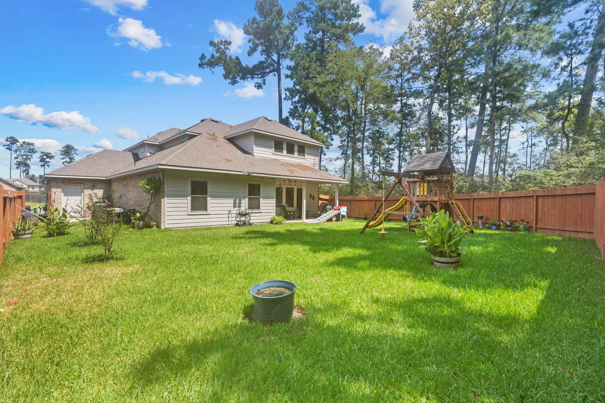 14388 Zion Gate Crossing Conroe, TX 77384 - Photo 30 of 33 a view of a house with a backyard
