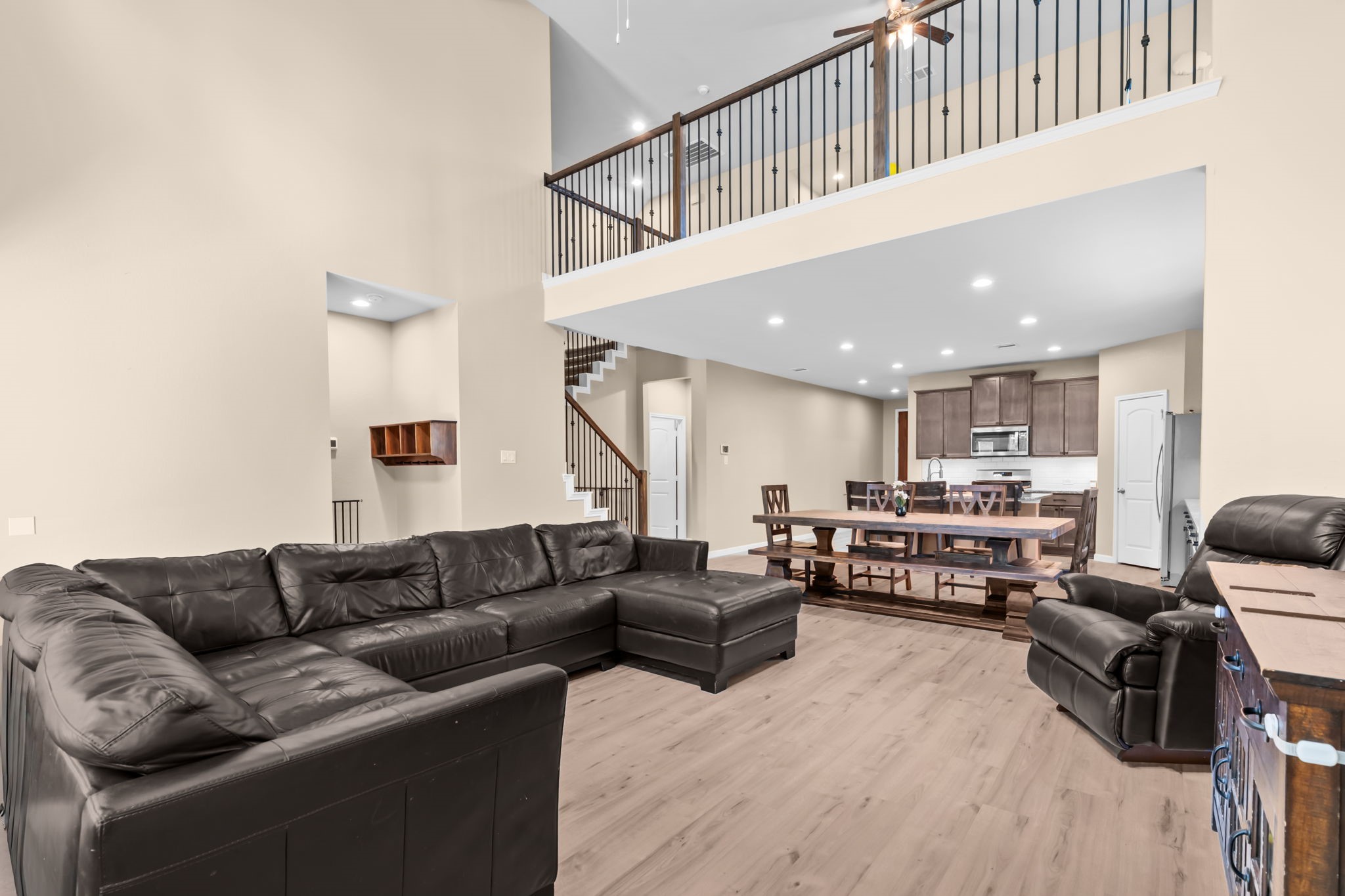 14388 Zion Gate Crossing Conroe, TX 77384 - Photo 10 of 33 a living room with furniture kitchen view and a wooden floor