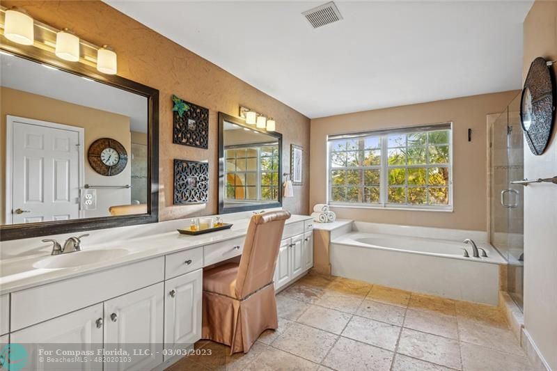 4290 Diamond Drive Weston, FL 33331 - Photo 12 of 26 a bathroom with a granite countertop sink mirror and a bathtub next to a window