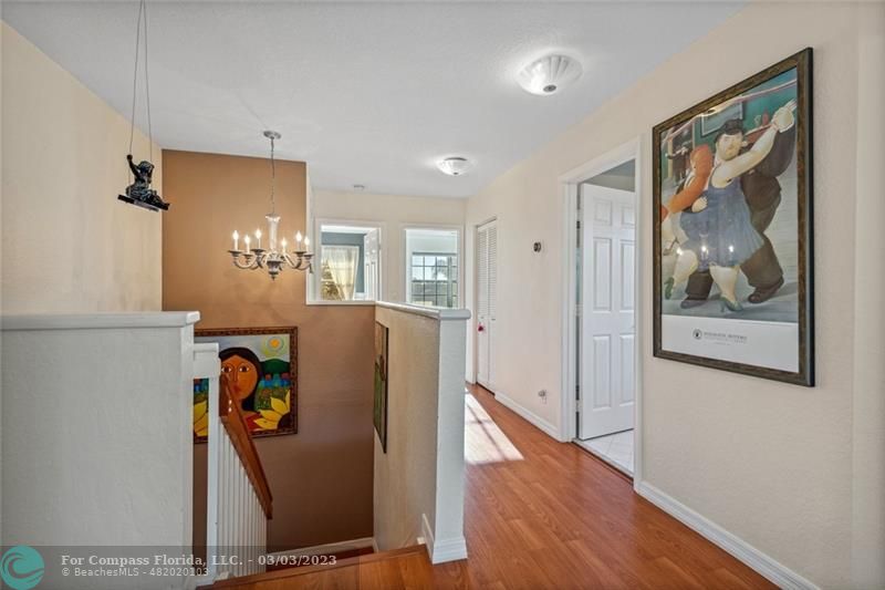 4290 Diamond Drive Weston, FL 33331 - Photo 17 of 26 a view of a hallway with paintings on the wall