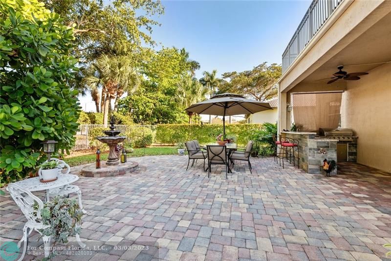 4290 Diamond Drive Weston, FL 33331 - Photo 21 of 26 a view of a patio with a table and chairs under an umbrella