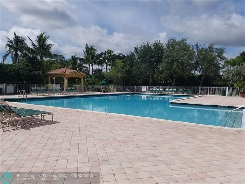 4290 Diamond Drive Weston, FL 33331 - Photo 25 of 26 a view of a swimming pool and deck in the backyard of house with lake view